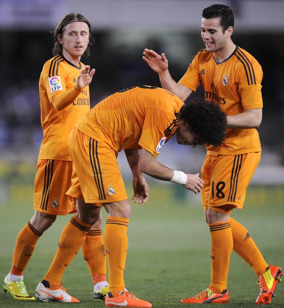 Real Madrid's Pepe of Portugal, center, celebrates his goal and the third of his team with Luka Modric of Croatia, left, and Jose Nacho, after scoring against Real Sociedad, during their Spanish League soccer match, at Anoeta stadium, in San Sebastian, Spain, Saturday, April 5, 2014. (AP Photo/Alvaro Barrientos)