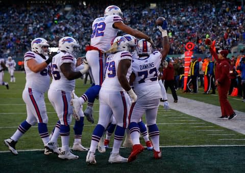 Buffalo Bills offensive tackle Dion Dawkins (73) celebrates with teammates after scoring a touchdown against the New York Jets during the second quarter at MetLife Stadium. - Credit: Noah K. Murray/USA Today