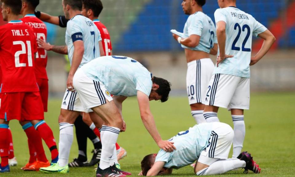 Scotland’s Billy Gilmour on his knees after a hard challenge that eventually forced him off.