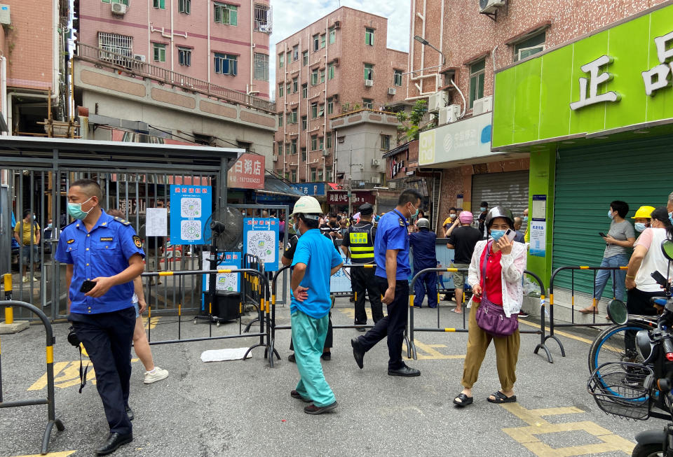 Security guards stand at an entrance to Wanxia urban village, which has been closed as part of coronavirus disease (COVID-19) control measures in Shenzhen, Guangdong province, China August 29, 2022. REUTERS/David Kirton