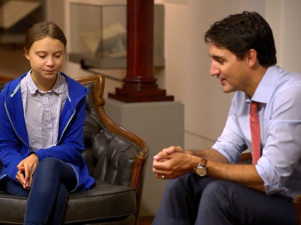 Canadian Prime Minister Justin Trudeau, right, sits down with Swedish climate change activist Greta Thunberg, in Montreal, in 2019 (Reuters)