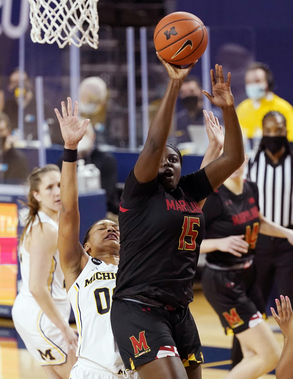 Maryland guard Ashley Owusu (15) takes a shot as Michigan forward Naz Hillmon (00) defends during the second half of an NCAA college basketball game, Thursday, March 4, 2021, in Ann Arbor, Mich. (AP Photo/Carlos Osorio)