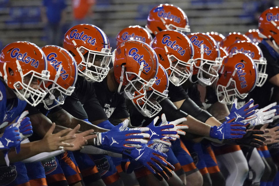 FILE - In this Dec. 12, 2020, file photo, Florida players get ready before an NCAA college football game in Gainesville, Fla. Florida’s athletic department had a $54.5 million shortfall during the 2020-21 fiscal year because of the coronavirus pandemic, significant financial losses the Gators were able to weather with a supplement from the Southeastern Conference and a sizeable reserve. (AP Photo/John Raoux, File)
