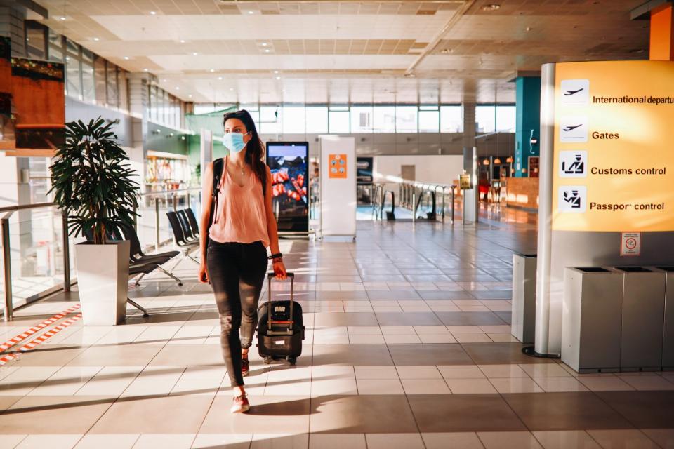 solo traveler wearing mask in airport