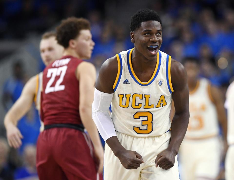 UCLA guard Aaron Holiday, right, celebrates after scoring as Washington State guard Malachi Flynn walks past during the second half of an NCAA college basketball game, Saturday, March 4, 2017, in Los Angeles. UCLA won 77-68. (AP Photo/Mark J. Terrill)