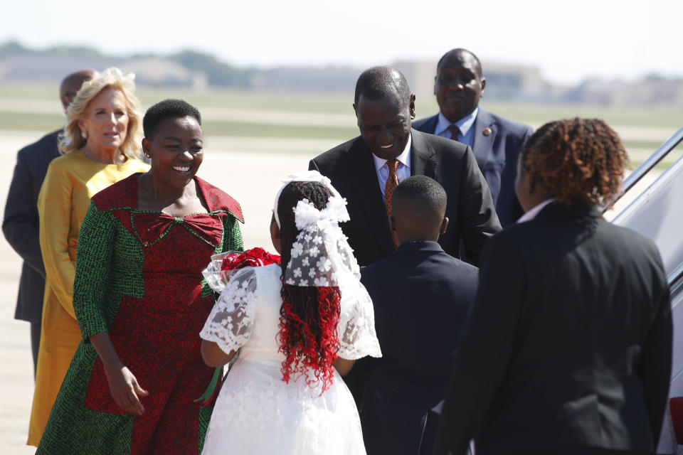 Kenya's President William Ruto, center, and first lady Rachel Ruto, second from left, arrive at Andrews Air Force Base, Md., Wednesday, May 22, 2024, for a state visit to the United States as first Lady Jill Biden, left, looks on. (AP Photo/Luis M. Alvarez)