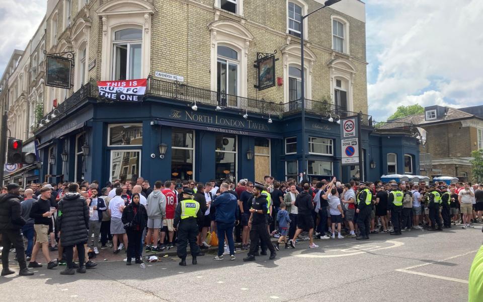 United fans gather outside the popular North London Tavern