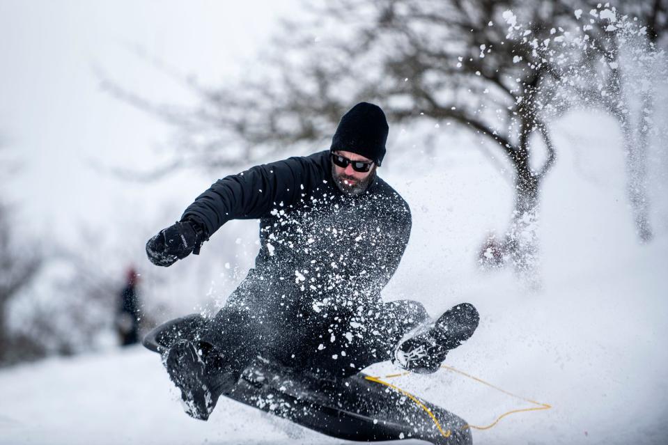 Chris Owens sleds down Dead Man's Hill in February 2021 at Leila Arboretum in Battle Creek.