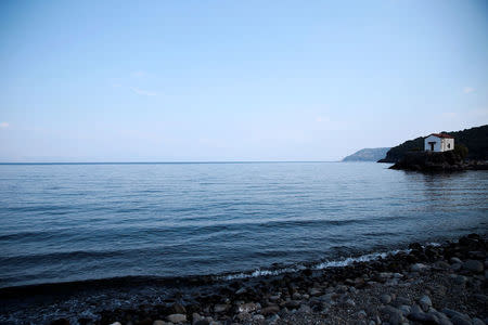 View of the beach of the Skala Sikamias village, with the church of Virgin Mary the Mermaid seen on the right, on the island of Lesbos, Greece, October 5, 2016. REUTERS/Alkis Konstantinidis