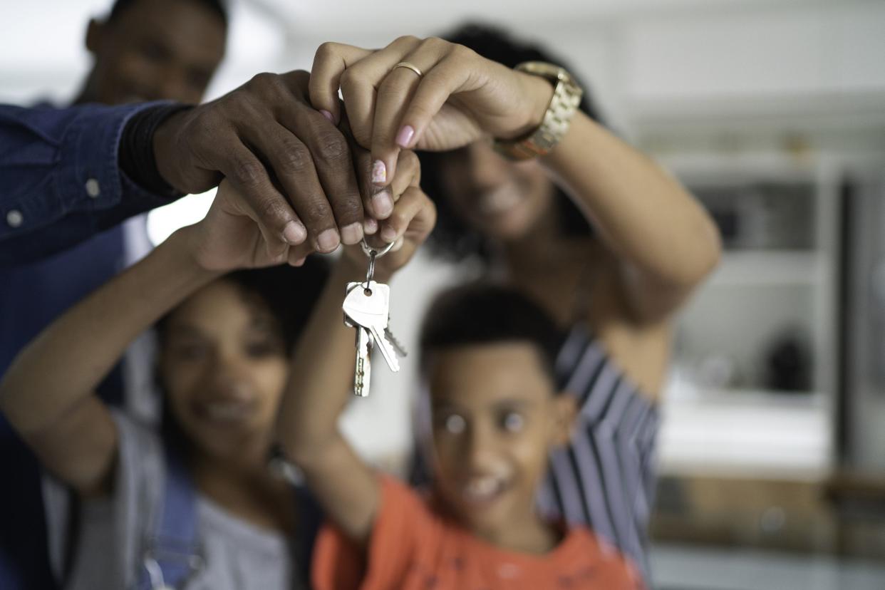 Latin family holding the keys of their new house