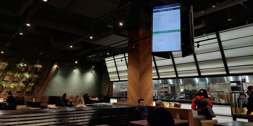 The interior & dining area of a Shake Shack restaurant in London