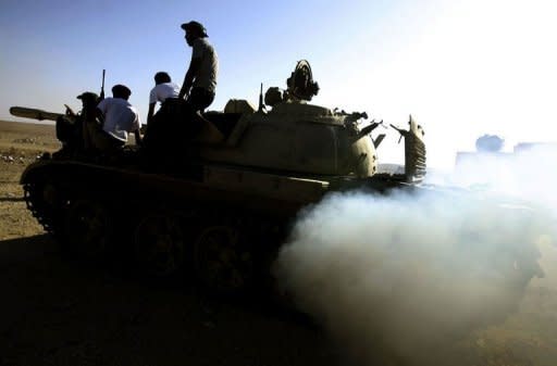 Libyan National Transitional Council (NTC) drive tanks at an outpost on the outskirts of the city of Bani Walid. Libya's new rulers on Wednesday declared victory in the battle for the key southern city of Sabha, one of the last bastions of deposed despot Moamer Kadhafi's diehard supporters