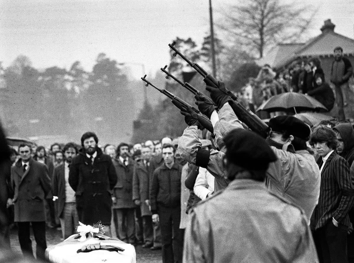 Masked men fire volleys of rifle shots in 1981 over the coffin of hunger-striker Bobby Sands (PA)