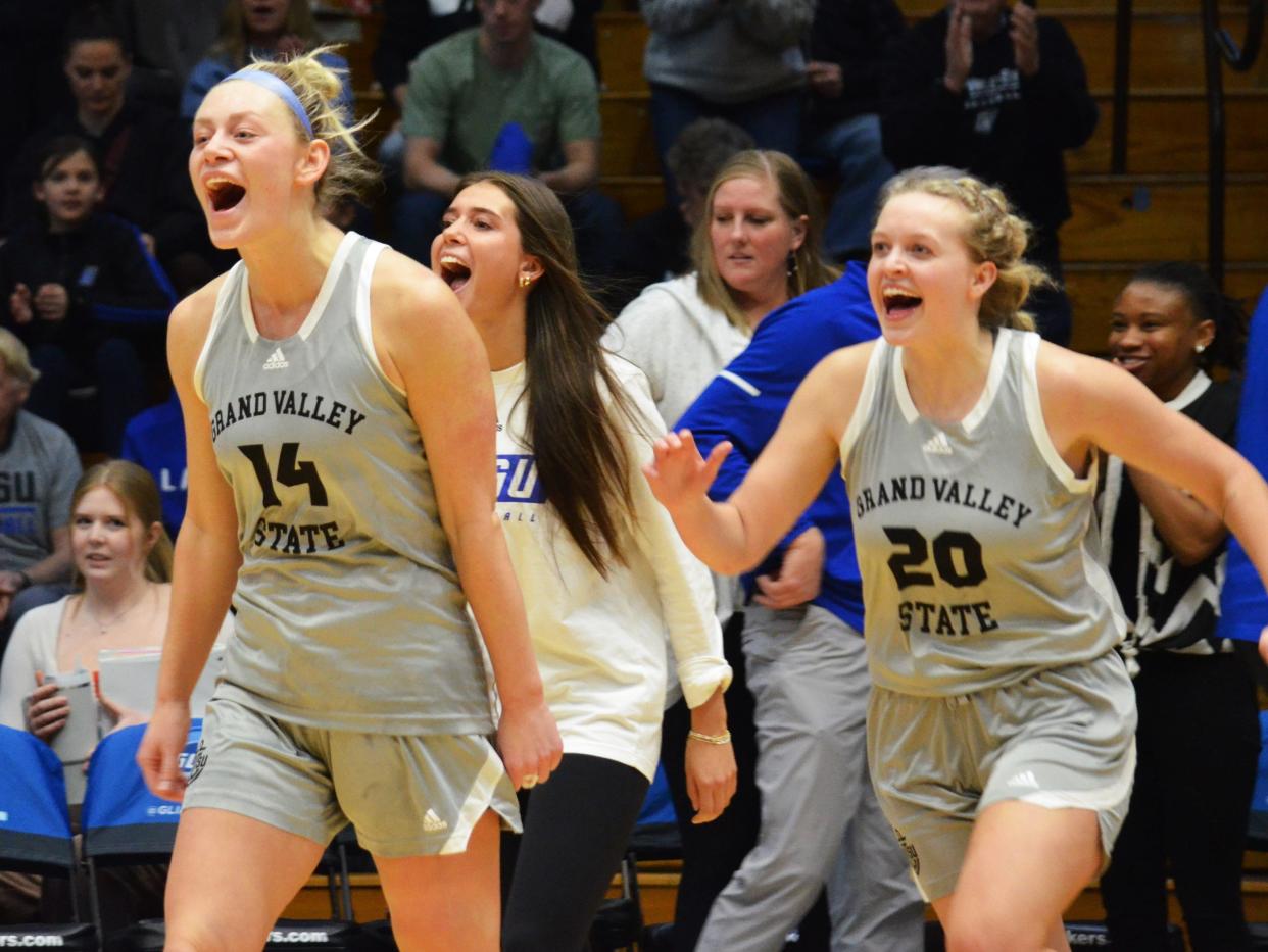 GVSU's Rylie Bisballe, left, Ellie Droste and Lexi Plitzuweit celebrate after beating Northern Michigan in the GLIAC Tournament finals on Sunday, March 10, 2024, at GVSU.