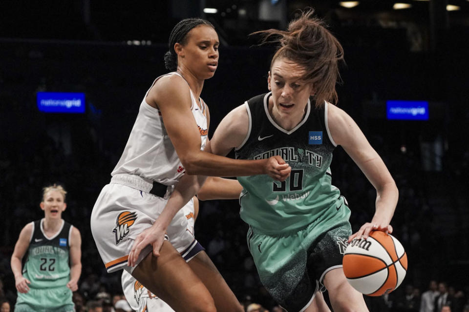 New York Liberty forward Breanna Stewart, right, drives to basket during the third quarter of a WNBA basketball game against the Phoenix Mercury, Sunday, June 18, 2023, in New York. (AP Photo/Bebeto Matthews)