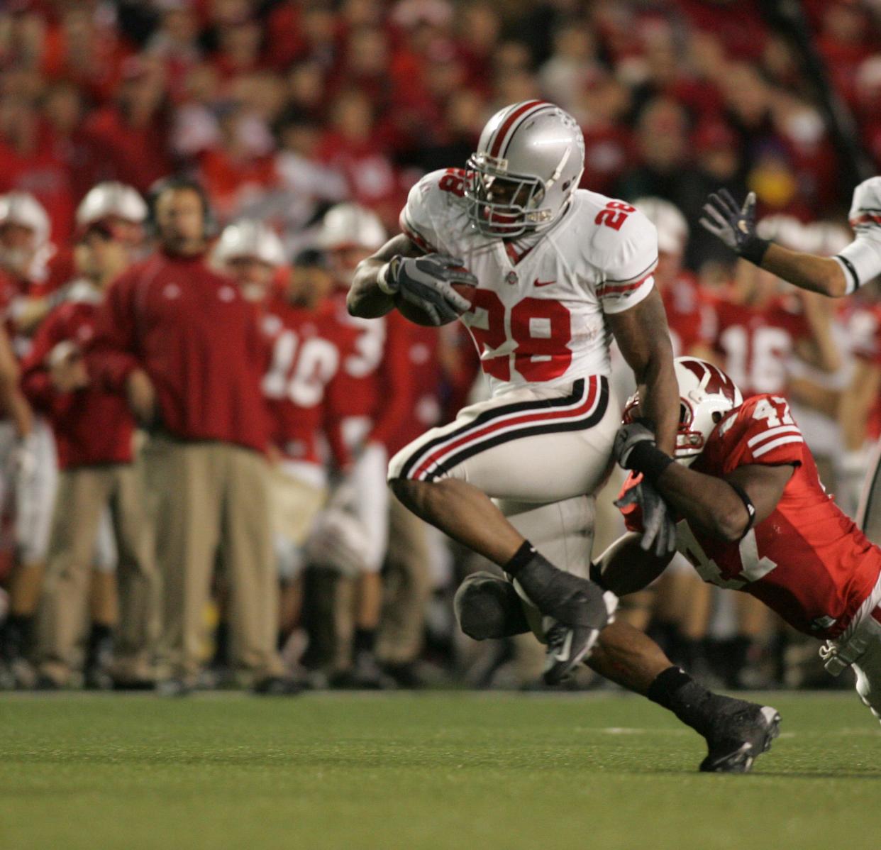 Ohio State's Chris Beanie Wells tries to elude Jaevery McFadden of Wisconsin during the third quarter, October 4, 2008, in Madison, Wisc.