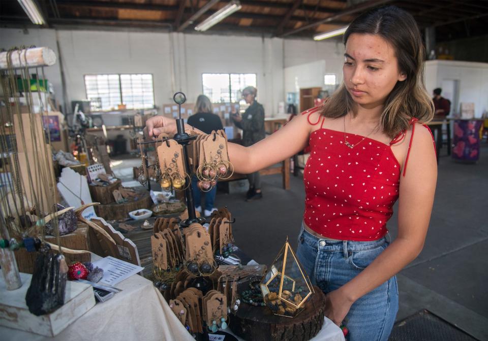 Maya Reyes takes a look at jewelry at a HATCH workshop Feb. 16, 2020, in downtown Stockton featuring food vendors and artisans selling clothing, jewelry, handbags and artwork. The HATCH will host a free Holiday Celebration Pop-Up with local vendors Dec. 11.