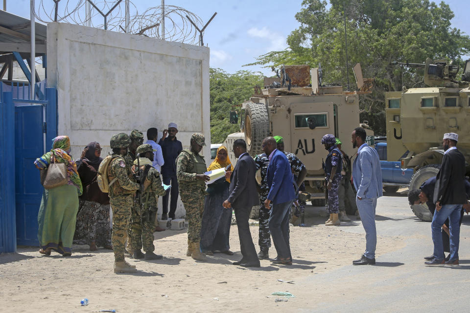 Somali lawmakers are checked by security forces as they arrive to cast their vote in the presidential election, at the Halane military camp which is protected by African Union peacekeepers, in Mogadishu, Somalia Sunday, May 15, 2022. Legislators in Somalia are meeting Sunday to elect the country's president in the capital, Mogadishu, which is under lockdown measures aimed at preventing deadly militant attacks. (AP Photo/Farah Abdi Warsameh)