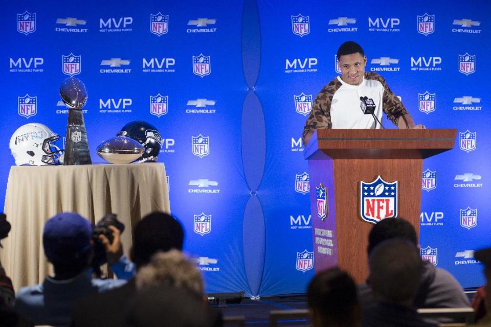 Seattle Seahawks linebacker and Super Bowl XLVIII MVP Malcolm Smith answers questions from the media during a news conference as the Vince Lombardi and MVP trophy rest on a table nearby at the Super Bowl Media Center at the Sheraton hotel, Monday, Feb. 3, 2014, in New York. The Seattle Seahawks defeated the Denver Broncos, 43-8. (AP Photo/John Minchillo)