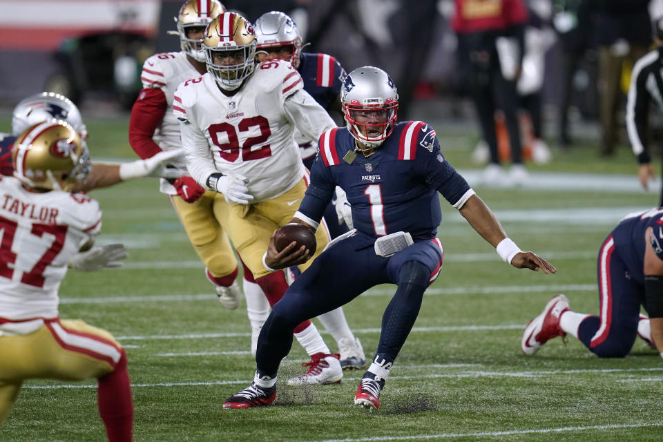 New England Patriots quarterback Cam Newton (1) scrambles away from San Francisco 49ers defenders Jamar Taylor, left, and Kerry Hyder Jr. (92) in the second half of an NFL football game, Sunday, Oct. 25, 2020, in Foxborough, Mass. (AP Photo/Charles Krupa)