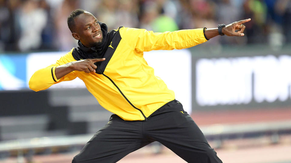 Seen here, Usain Bolt does his trademark pose for photographers.