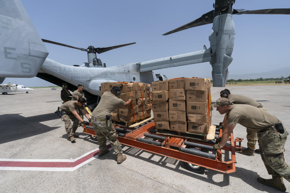 Food is loaded onto a VM-22 Osprey at Toussaint Louverture International Airport, Saturday, Aug. 28, 2021, in Port-au-Prince, Haiti. The VMM-266, "Fighting Griffins," from Marine Corps Air Station New River, from Jacksonville, N.C., are flying in support of Joint Task Force Haiti after a 7.2 magnitude earthquake on Aug. 22, caused heavy damage to the country. (AP Photo/Alex Brandon)