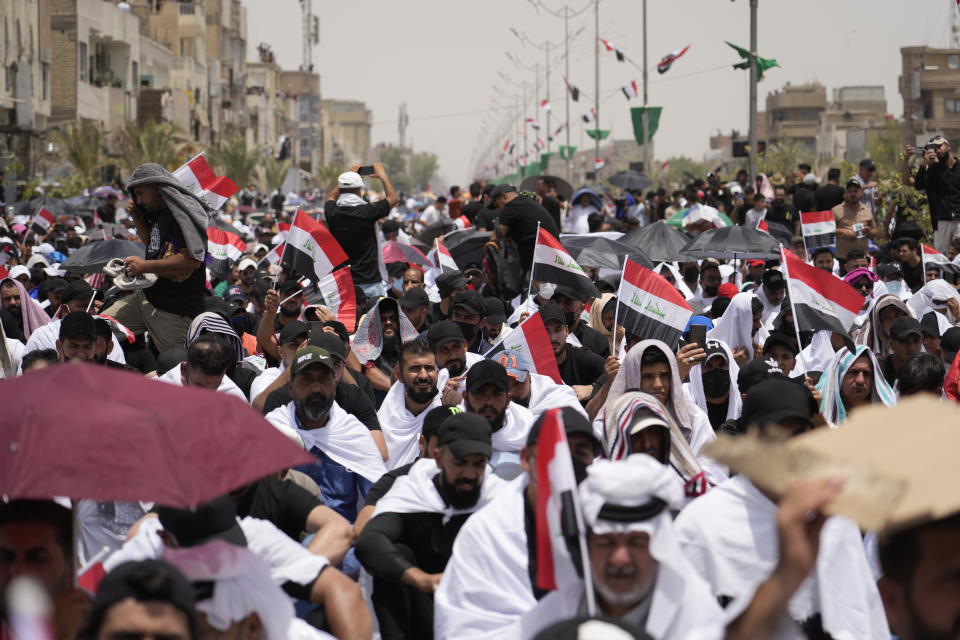 Followers of Shiite cleric Muqtada al-Sadr chant slogans during an open-air Friday prayers in Sadr City, Baghdad, Iraq, Friday, July 15, 2022. (AP Photo/Hadi Mizban)