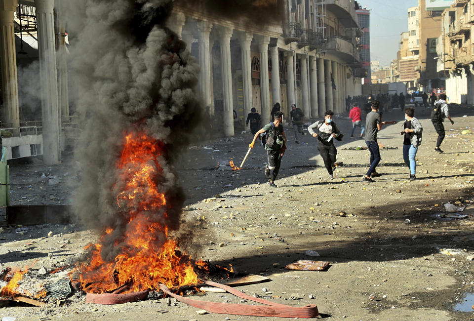 Riot police try to disperse anti-government protesters during clashes in Baghdad, Iraq, Nov. 22, 2019. (Photo: Hadi Mizban/AP)