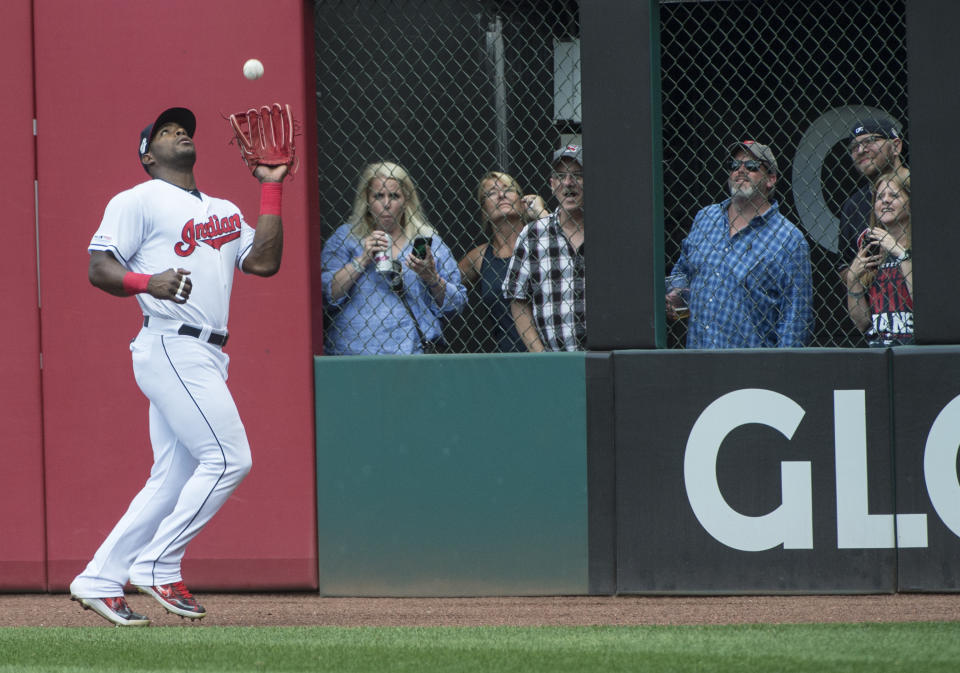 Cleveland Indians' Yasiel Puig catches a fly ball by Texas Rangers' Hunter Pence during the sixth inning of the first game of a baseball doubleheader in Cleveland, Wednesday, Aug. 7, 2019. (AP Photo/Phil Long)