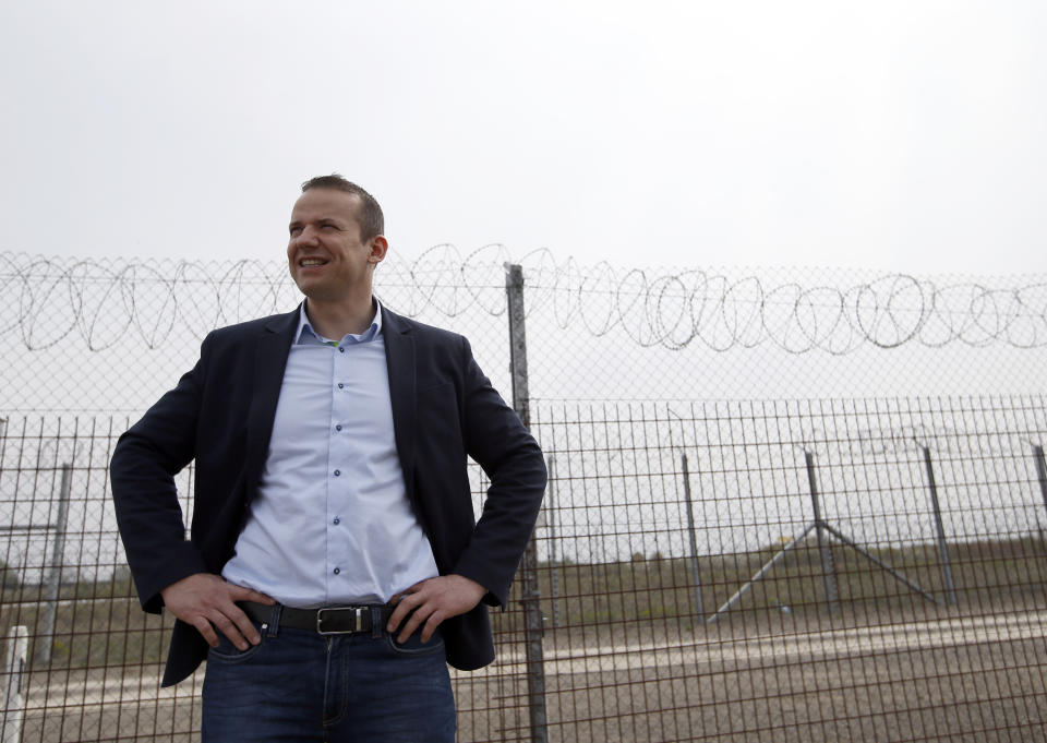 In this photo taken Monday, April 8, 2019, Asotthalom's mayor Laszlo Toroczkai speaks in front of the fence at Hungary's border with Serbia near the village Asotthalom, Hungary. With a campaign centered on stopping immigration, Hungary’s ruling Fidesz party is expected to continue its dominance in the European Parliament election at the end of May. Torczkai, who is critical of government corruption and some of Hungarian Prime Minister Viktor Orban's economic policies, still appreciates the border fence that Orban built to stop migrants from entering the country. Torczkai says: “On this we agree _ migration must be stopped.” (AP Photo/Darko Vojinovic)
