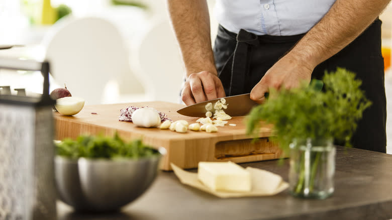 person slicing garlic