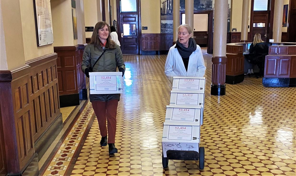 Reina Pohl, left and Kerry Foley with the Physicians Committee for Responsible Medicine on Thursday, March 2, 2023, deliver boxes containing 52,454 petition signatures to Mun Choi's office, asking the MU chancellor and system president to end the use of live animals to train medical residents.