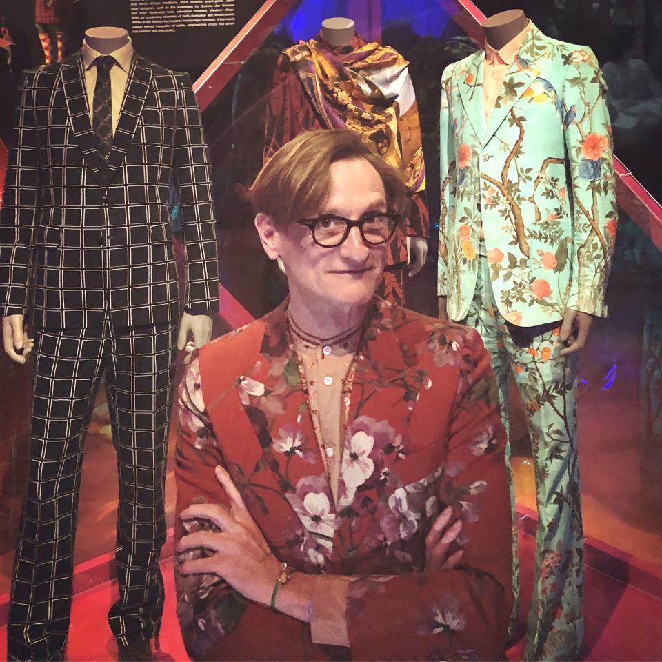 <h1 class="title"><em>Vogue</em>'s Hamish Bowles in a Gucci suit. Beyond, his own Gucci suit, on display in the exhibition.</h1><cite class="credit">Photo: Hamish Bowles</cite>