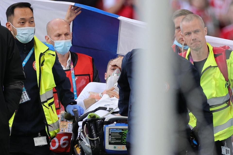 Denmark's midfielder Christian Eriksen is evacuated after collapsing on the pitch during the UEFA EURO 2020 Group B football match between Denmark and Finland (AFP via Getty)