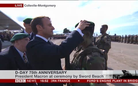 Macron presents a young commando with his green beret - Credit: BBC
