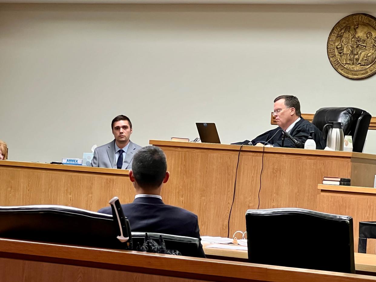 Alex Christian Hollinger, left, testifies during his trial at the New Hanover County Courthouse on Tuesday, Aug. 16, 2022.