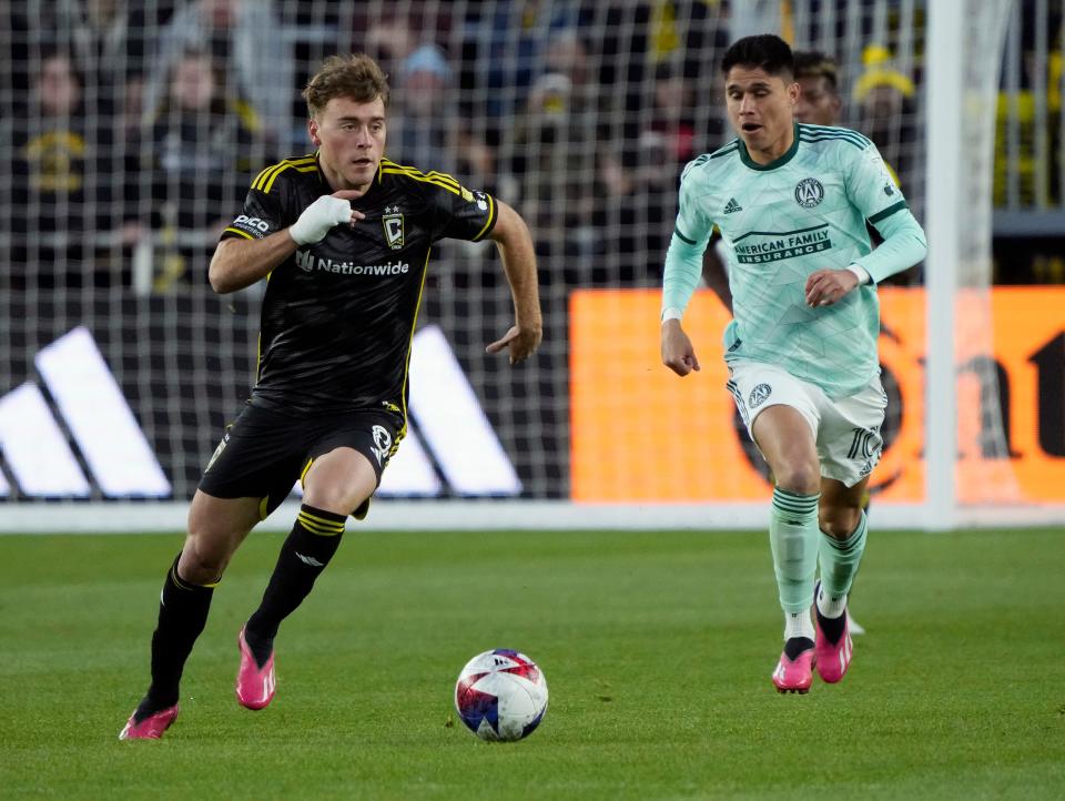 Mar 25, 2023; Columbus, Ohio, USA; Columbus Crew midfielder Aidan Morris (8) dribbles up field against Atlanta United midfielder Luiz Araujo (10) during the first half of their MLS game at Lower.com Stadium. 