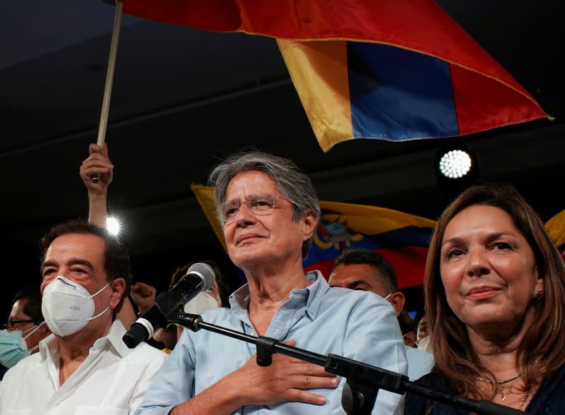 El candidato presidencial Guillermo Lasso (centro) saluda a sus partidarios junto a su esposa, María de Lourdes Alcivar, y el exalcalde de Guayaquil Jaime Nebot tras ganar la presidencia en Guayaquil, Ecuador.