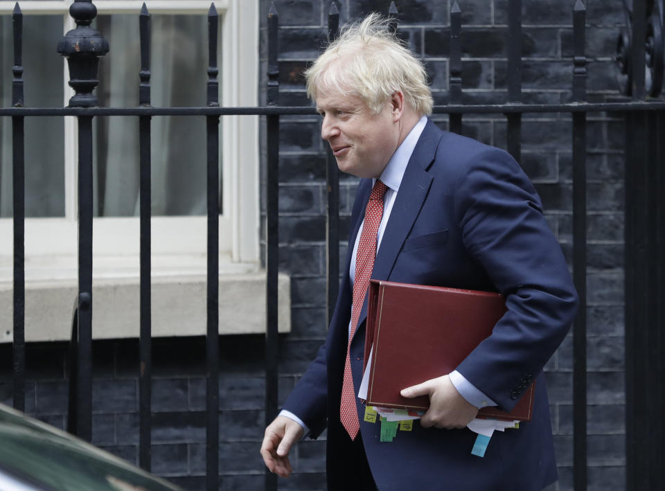 Britain's Prime Minister Boris Johnson leaves 10 Downing Street to attend the weekley session of Prime Ministers Questions in Parliament in London, Wednesday, Jan. 22, 2020. (AP Photo/Kirsty Wigglesworth)