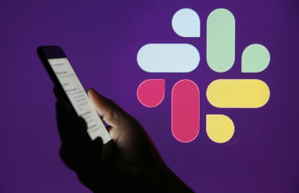 PARIS, FRANCE - FEBRUARY 06: In this photo illustration, the Slack logo is displayed on the screen of an Apple iPhone in front of a computer screen displaying a Slack logo on February 06, 2019 in Paris, France. Slack announced in a statement that it had "confidentially" filed its file with the SEC for an IPO. Launched in 2014 in San Francisco, the US Enterprise Messaging boasts 10 million daily active users in more than 150 countries worldwide. (Photo by Chesnot/Getty Images)