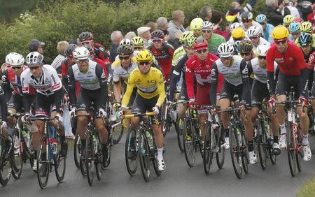 Cycling - Tour de France cycling race - The 183-km (113 miles) Stage 2 from Saint-Lo to Cherbourg-en-Contentin, France - 03/07/2016 - Team Dimension Data rider and yellow jersey leader Mark Cavendish of Britain (C) leads the pack of riders during the stage - REUTERS/Juan Medina