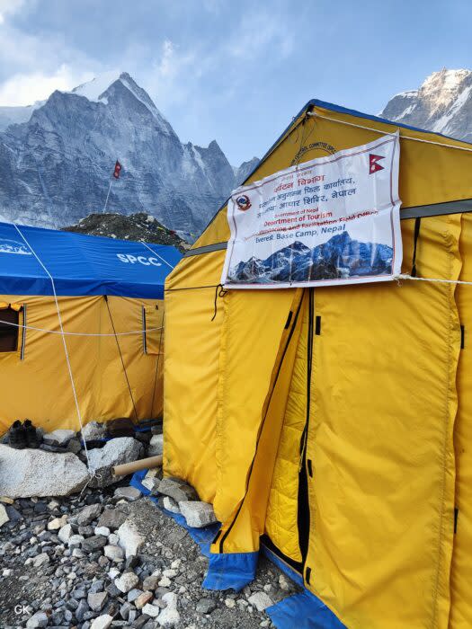 A tent with the logo of the Expedition Monitoring and Facilitation Field Office at Everest base camp