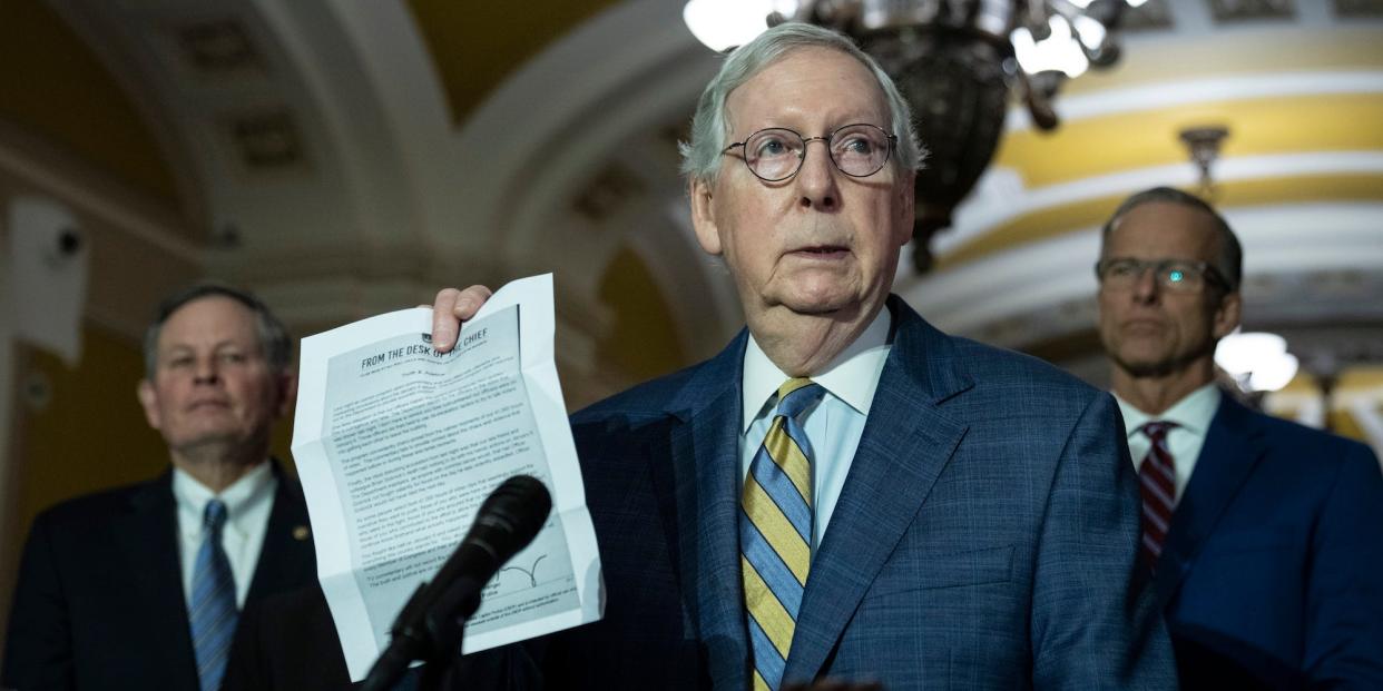 Senate Minority Leader Mitch McConnell holds up a letter from the Capitol Police chief at a press conference on March 7, 2023.