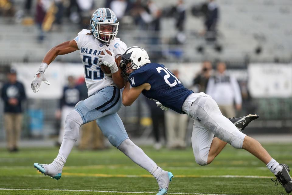 Central Valley's Landon Alexander (23) tries to break free of a tackle by Wyomissing's Charles McIntyre (20) in the PIAA Class 3A championship football game in December.