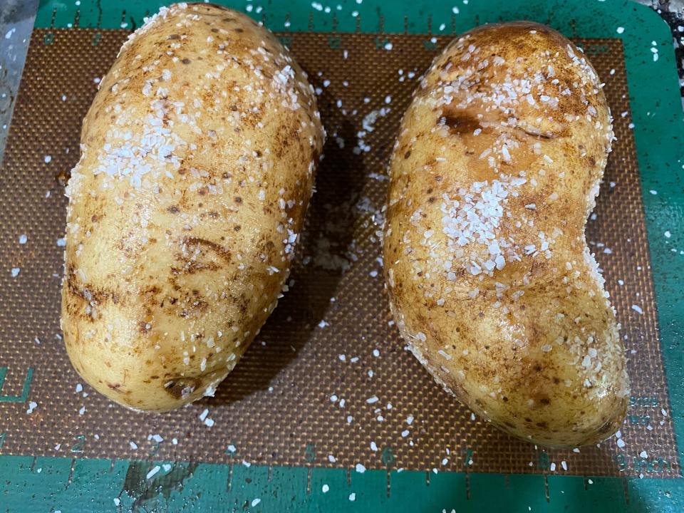 potatoes coated in salt and oil on a baking sheet