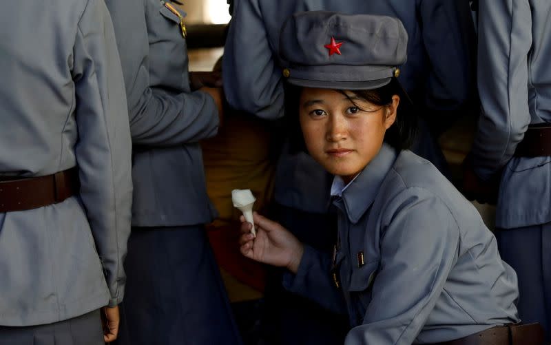 FILE PHOTO: Soldier eats ice cream as she visits a zoo in Pyongyang