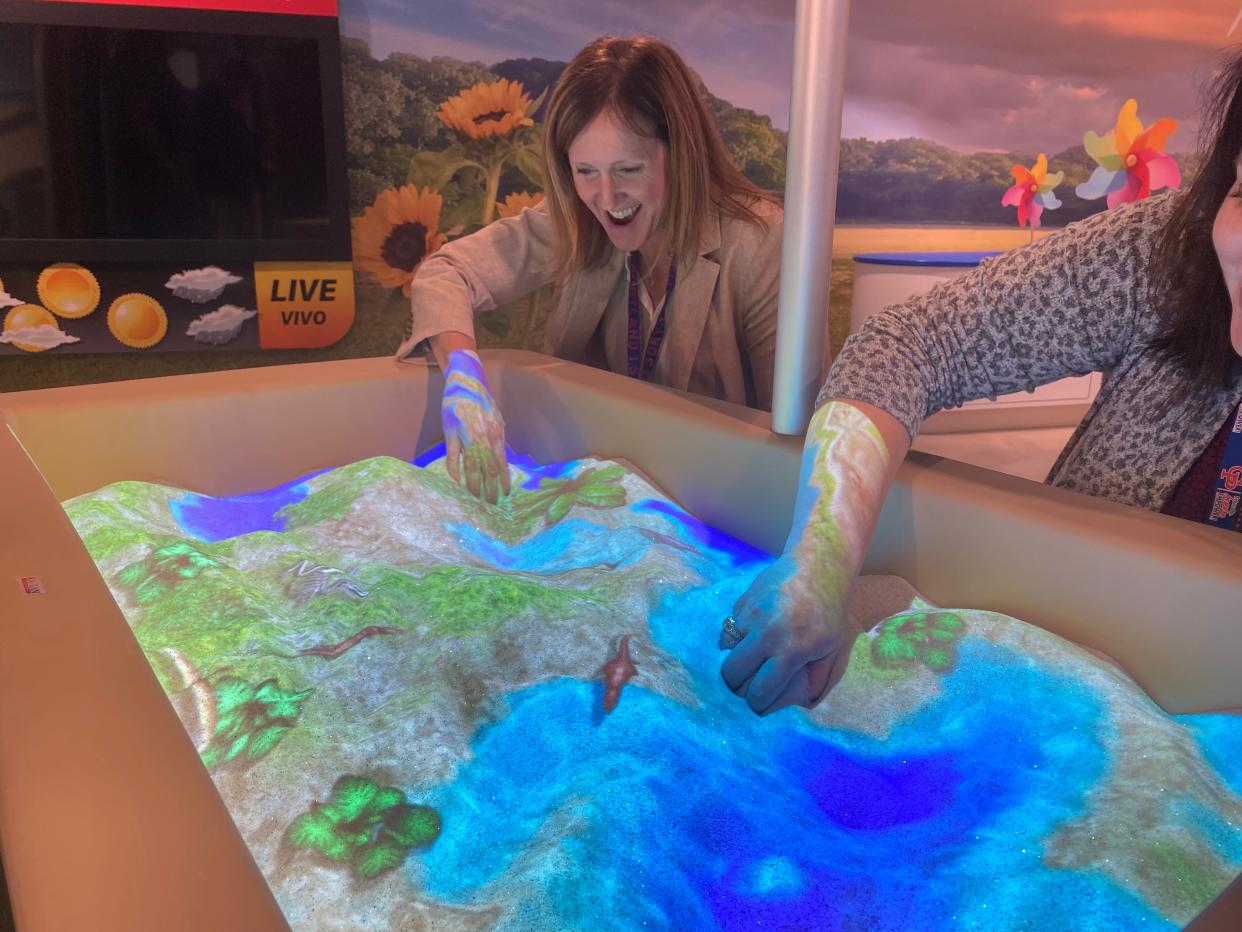 Gregory-Portland ISD Superintendent Michelle Cavazos (left) and district chief communications and engagement officer Crystal Matern try out an interactive sandbox Wednesday morning at the Early Childhood Center, which is nearing completion.