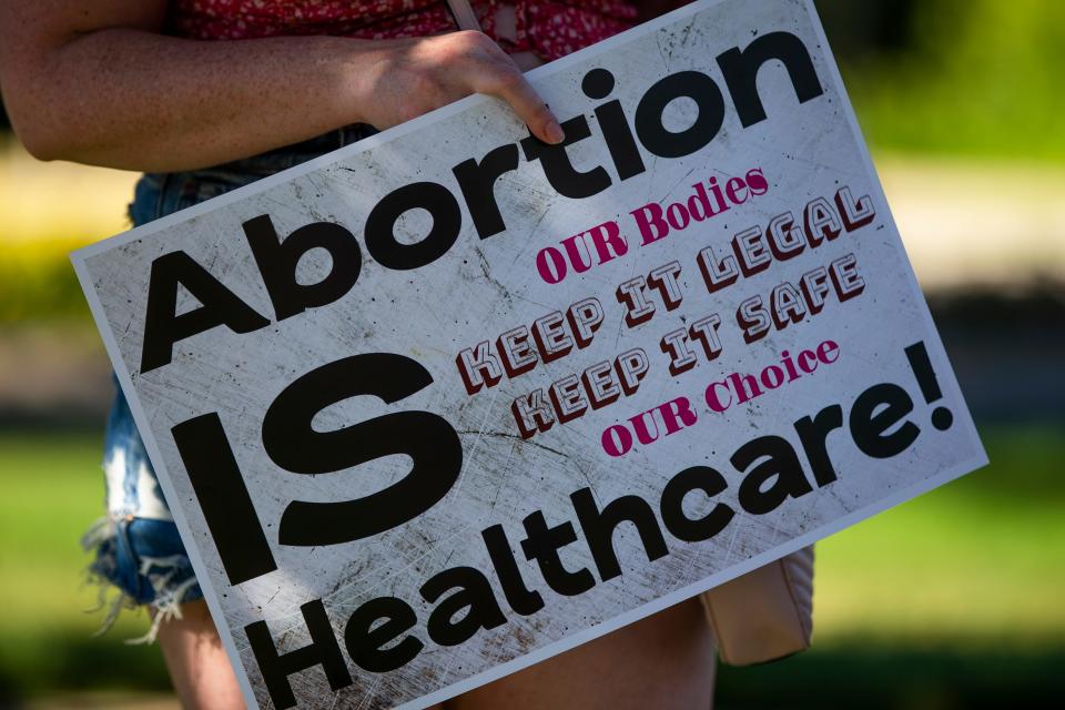 Attendees  hold signs during a rally opposing the Supreme Court decision overturning Roe v Wade on Friday, June 24, 2022, at the Jon R. Hunt Plaza in downtown South Bend.