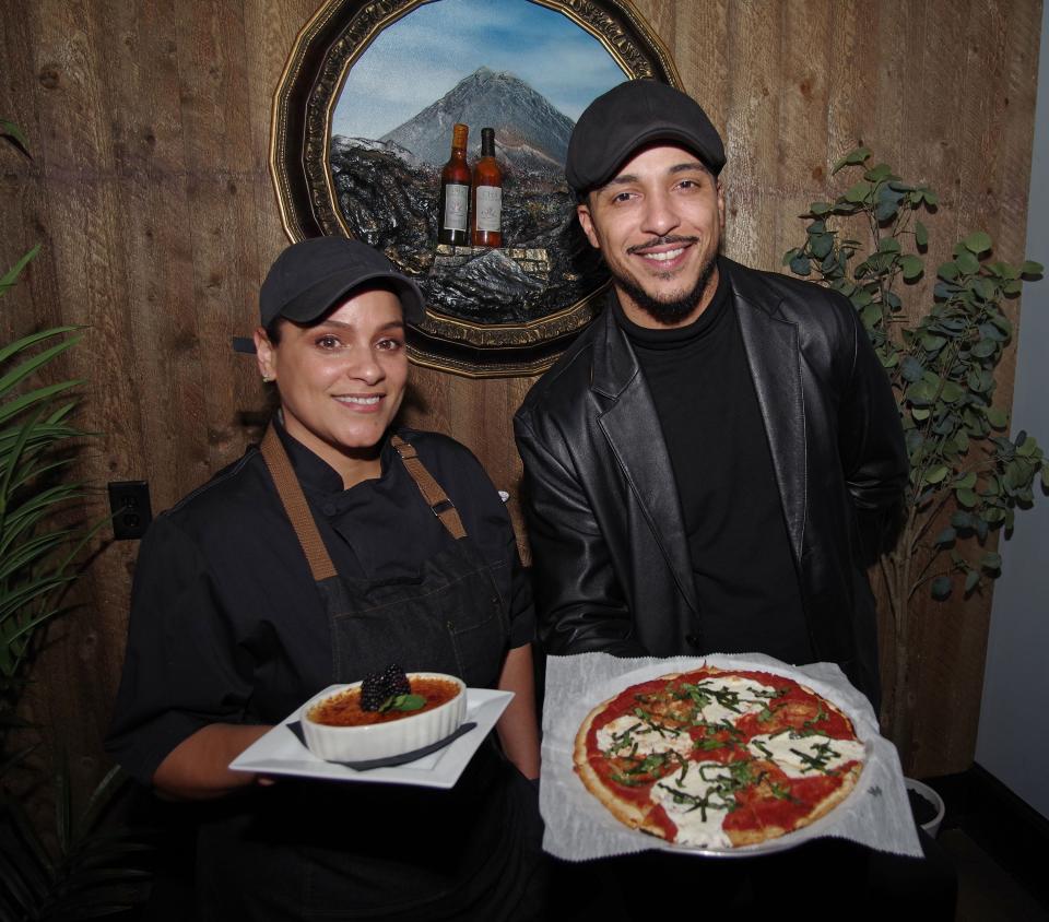 From left, Brockton Café Bar & Grill head chef Margarita Ramos and manager Shane Perkins show dishes the restaurant has become known for, crème brûlée and Margherita pizza, on Wednesday, Dec. 27, 2023.