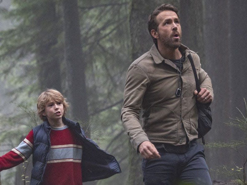 Walker Scobell in a vest, Ryan Reynolds in a cream jacket